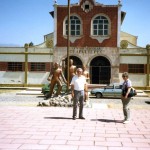 Mom and Dad standing in Front of our old school 